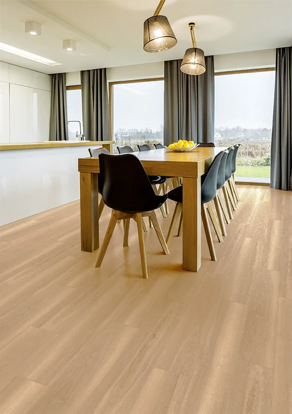Modern dining area featuring SmartDrop 7-Desert Dune light wood flooring, a wooden table with black and wood chairs, pendant lights, large windows, and a bowl of lemons on the table.